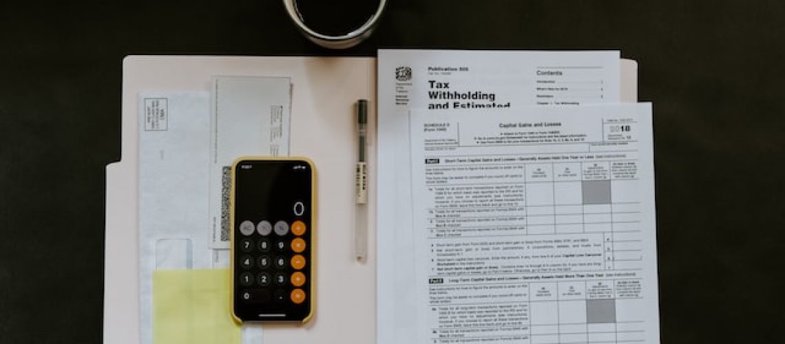 calculator on stack of tax forms
